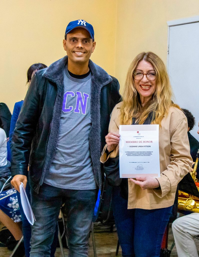 Dr. Raul Leandro Rojas, Dean of the Faculty of Music for ISA presents Suzanne Pittson with a certificate making her an honorary member of the Chano Pozzo International Center for Music Study